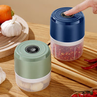 Two handheld food choppers on a wooden surface with ingredients around.

Electric garlic chopper
Mini garlic masher
Electric garlic grinder
USB garlic masher
Small electric food chopper
Garlic mincer machine
Portable garlic masher
Electric vegetable chopper
Garlic crusher electric
Kitchen garlic masher